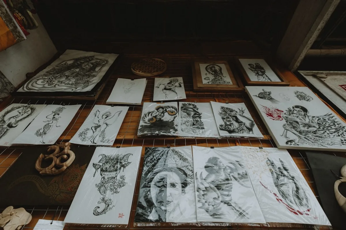 Collection of intricate drawings displayed on a wall.