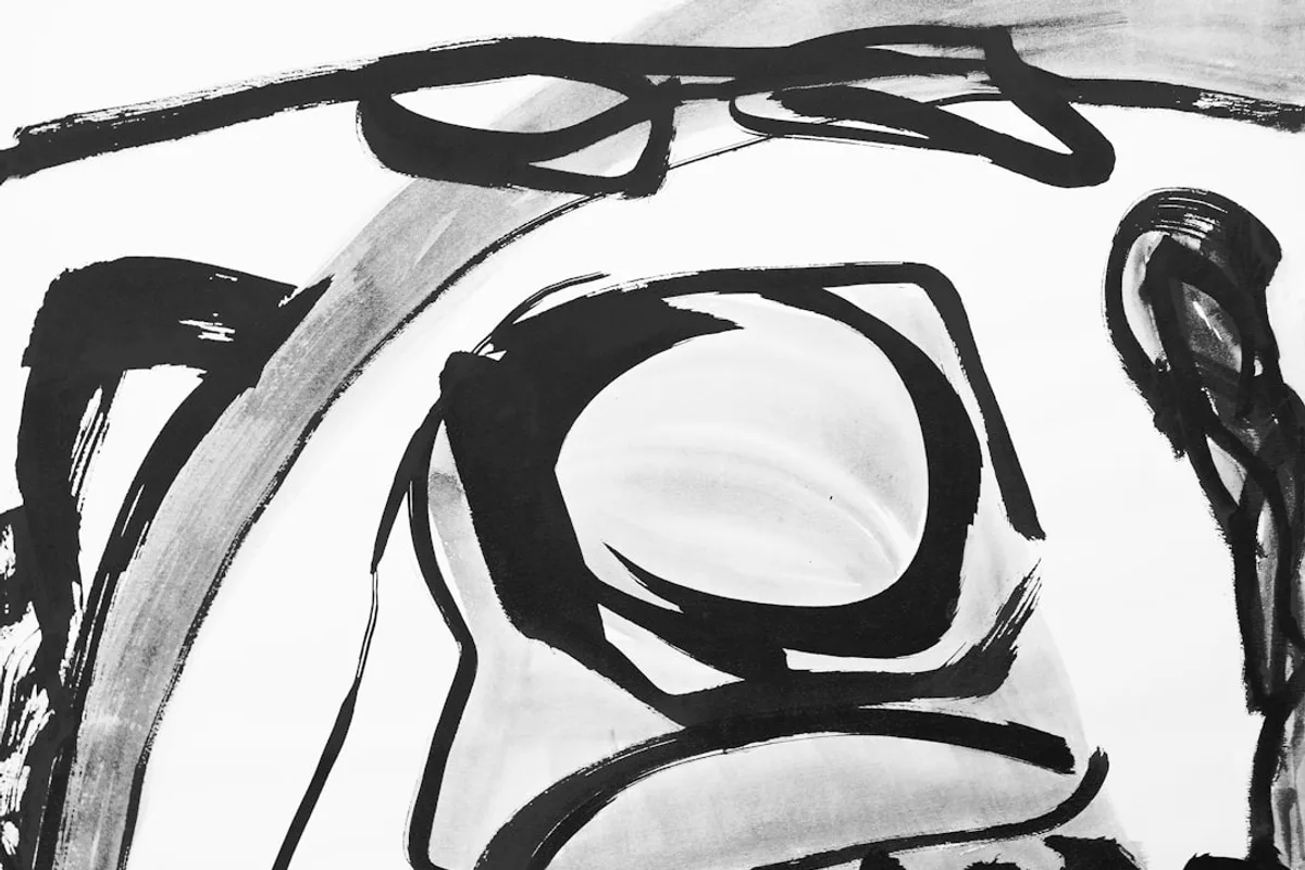 Abstract black and white brush strokes create a face