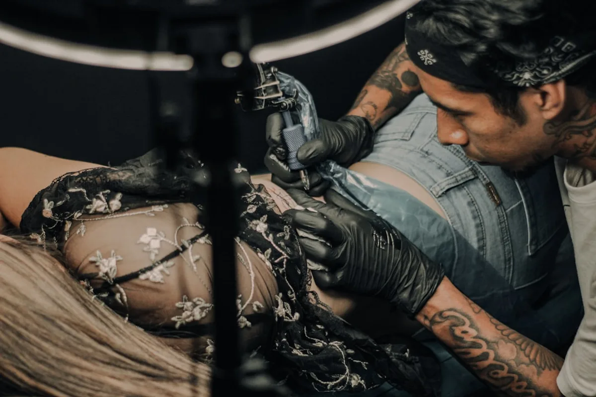 a man working on a tattoo