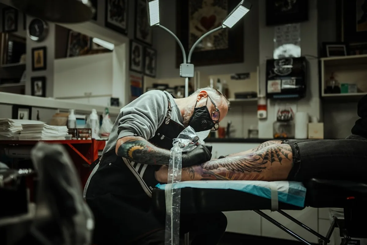 a man getting a tattoo on his arm