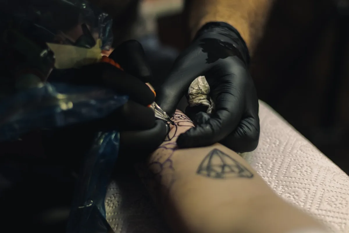 a person getting a tattoo on their arm