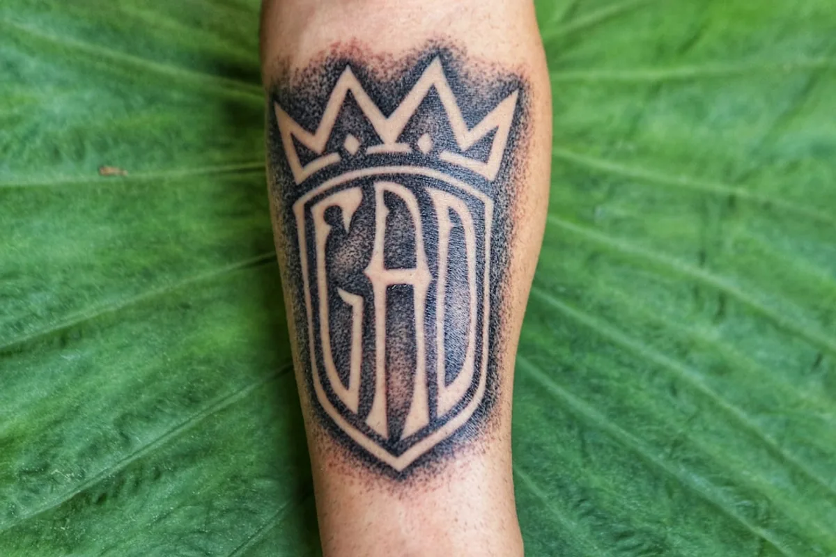 GAD text arm tattoo