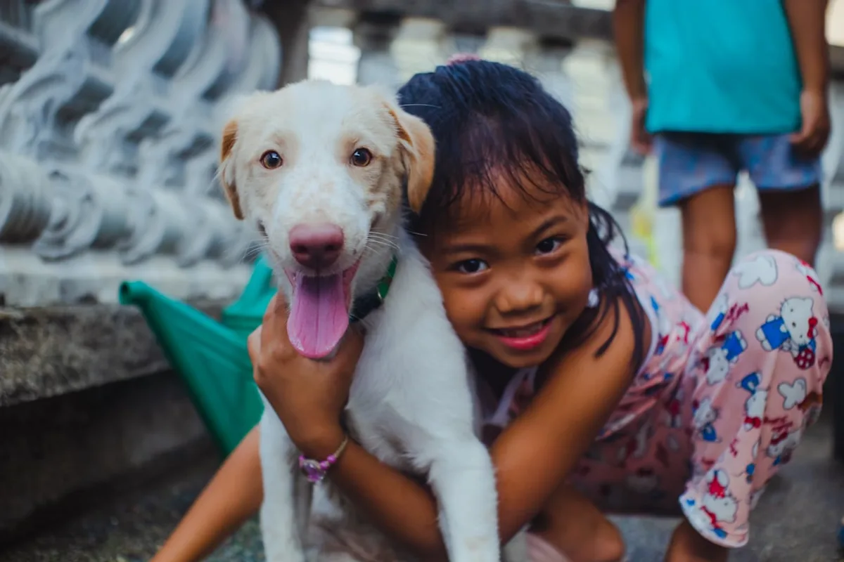 a girl holding a dog