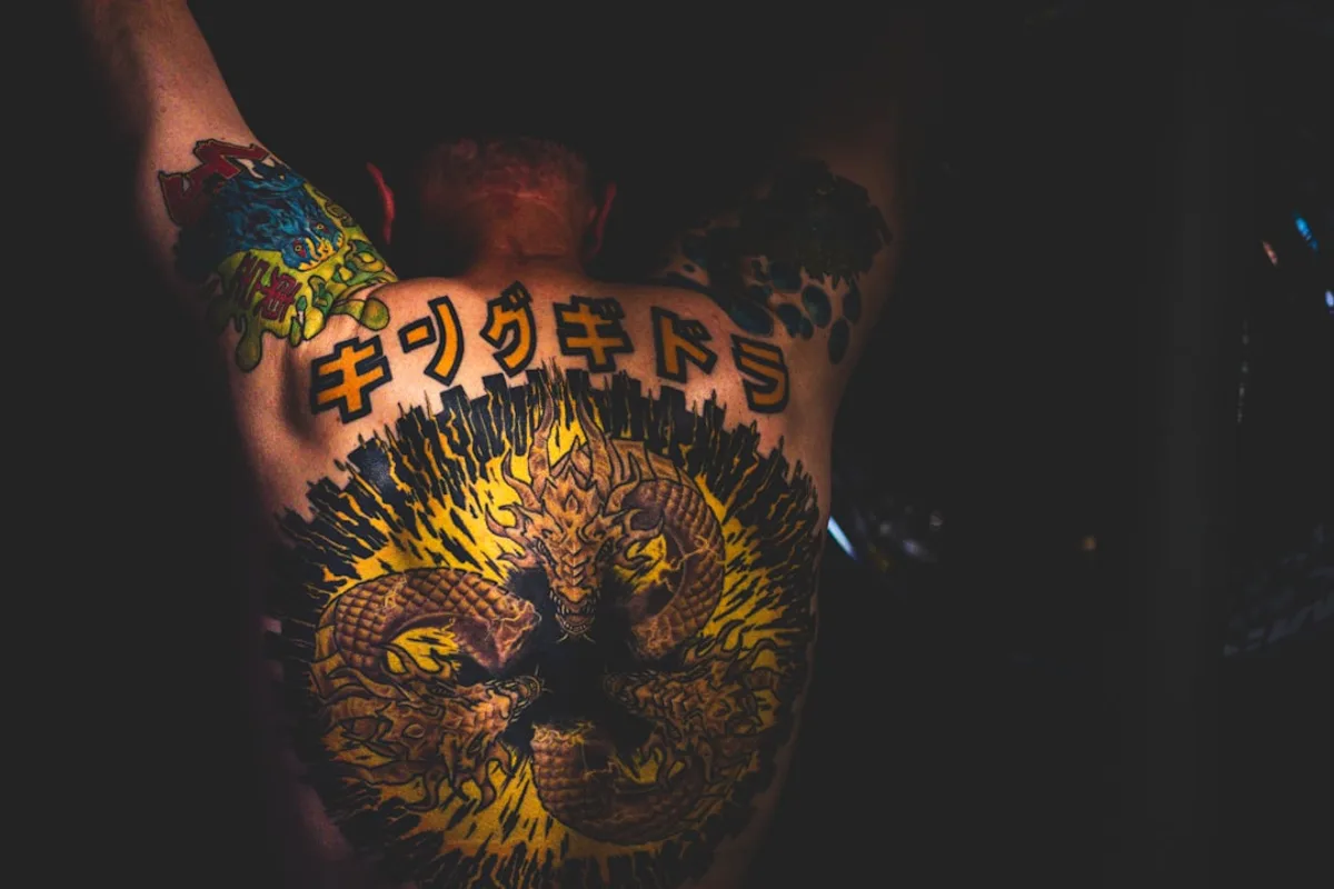 a man with a tattoo on his back